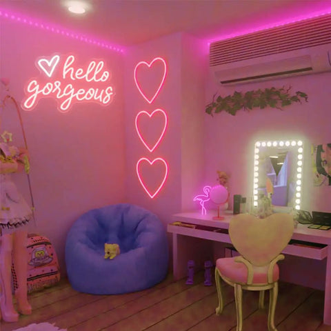 Hello Gorgeous Neon Sign LED Neon Light Heart Wall Decor in girl bedroom with makeup table and bean bag chair.