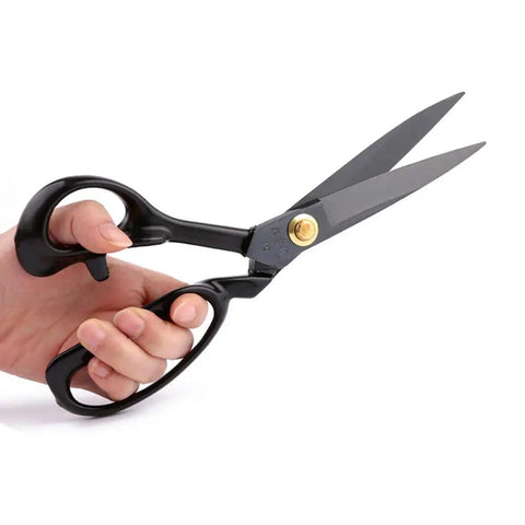 Left Handed Tailor Scissors 10 Inch Heavy Duty Dressmaking Shears Forged From Industrial Strength High Carbon Steel held in hand.