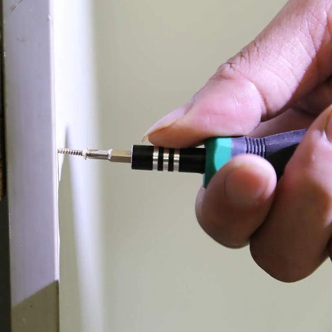 Close-up of installing screw from 1600Pcs 2mm Phillips Flat Head Self Tapping Tiny Screws Set for DIY Woodworking and Electronics Cabinets