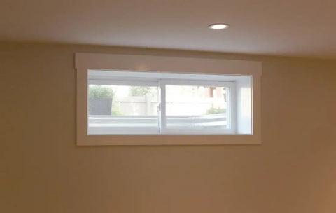 Vinyl Basement Slider Window 32 By 18 Inches White Built Tough With Heavy Duty Welded Sash And Main Frame, viewed indoors.