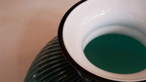 Close-up of 10 Inch Ribbed Student Lamp Shade In Cased Green Over Opal Design For Vintage And Antique Lighting, showing polished edge.