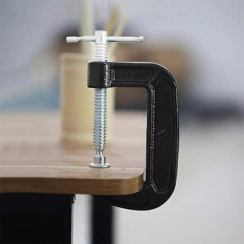 Side view of a Beefy 2 Inch C Clamp from the set, secured to a wooden surface, showing the industrial strength steel and anti-slip screws.