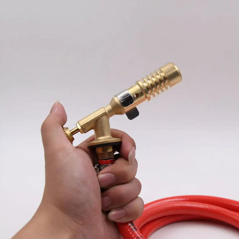 Premium Replaceable Propane Torch For Welding And Brazing With Self Ignition Lock in hand, showcasing ergonomic brass design and hose.