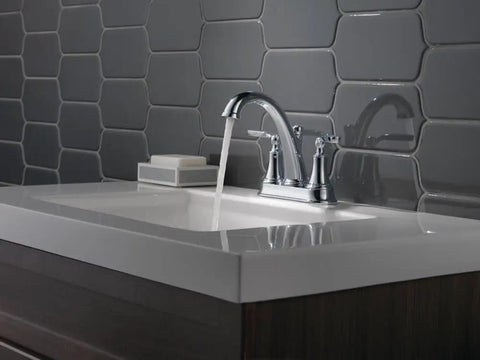 Woodhurst Centerset Chrome Two-Handle Bathroom Faucet for modern sinks with push-pop drain assembly shown installed