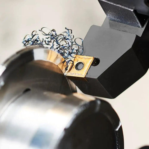 Close-up of 7 Piece 3/8 Inch Shank Indexable Carbide Lathe Turning Tool Set cutting steel with shavings visible.