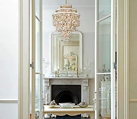 Elegant living room view featuring a chandelier and a fireplace with a polished silver finish, showcasing sharp crystal accents.
