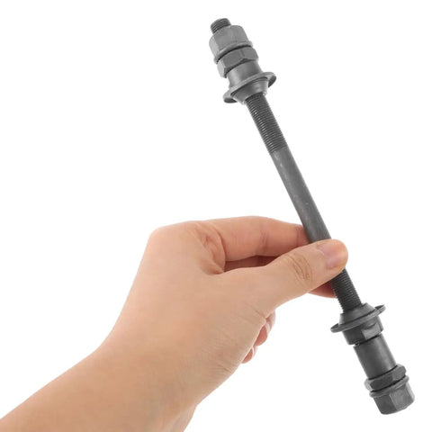 Hand holding 180Mm Rear Bicycle Axle For Mountain Bikes Grey Steel Hub With Ball Bearings Durable Shaft For 26 Inch Wheels