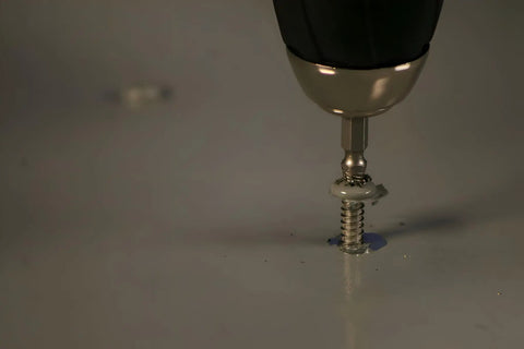 Close-up of 8440P Pro Grabit Broken Bolt And Damaged Screw Extractor in use on metal surface with cordless drill attachment.