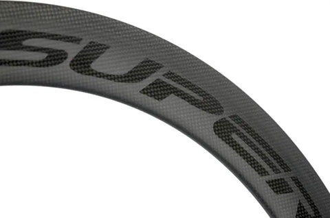Close-up of Carbon Fiber 56mm Clincher Wheel TriSpoke Wheelset with 3K matte finish for Road Bike, Novatec hubs visible.