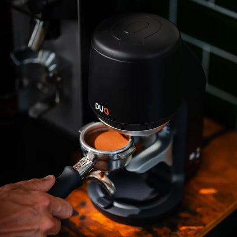 Electric Auto Leveling Espresso Tamper For 57.3 Mm Portafilters with portafilter and tamper, showcasing use in home kitchen.