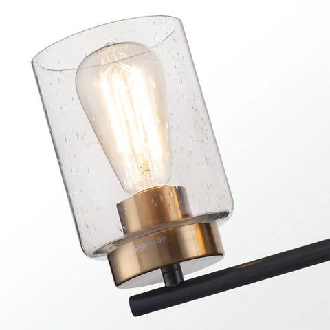 Close-up of Vintage Vibe 31 Inch Bathroom Vanity Light Fixture With Four Lights Seeded Glass Shades Gold Lamp Base On Black Metal Backplate