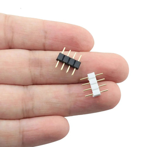 Hand holding black and white connectors from 60 Pack 4 Pin LED Connector Adapter For RGB LED Strips 3528 5050 Dual Male Pin Plug