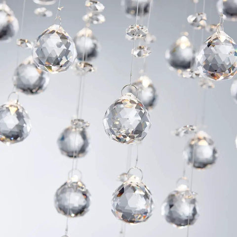 Close-up of hanging crystals from Lit Modern Crystal Round Raindrop Chandelier Flush Mount LED Ceiling Light Fixture.
