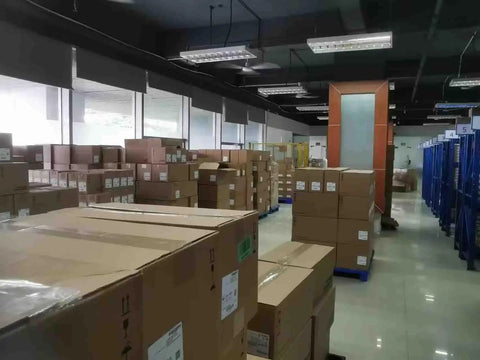 Warehouse with boxes, possibly containing 2080-LC20-20QBB Micro820 20 I O ENet IP Controller PLC New Sealed In Box For Industrial Automation