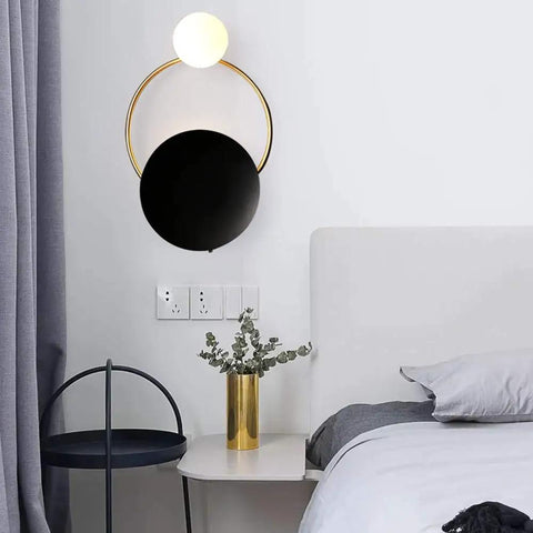 Fresh Modern LED Wall Sconce With Sturdy Iron Body, circular black and gold design, ambient lighting for bedrooms.