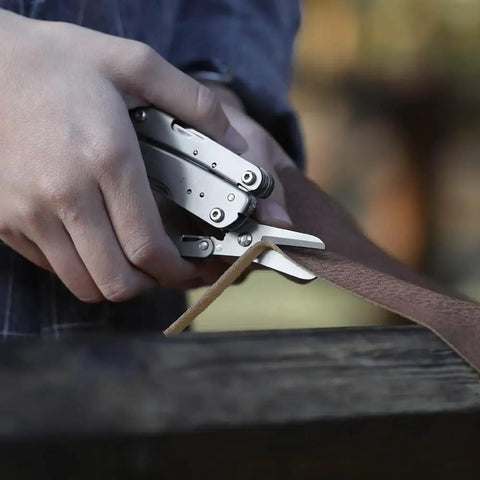 Person using 14 In 1 Mini Multitool Lightweight With Folding Scissors And 9 Piece Bit Set Holder Belt Clip Included Compact Storm Style Multi Tool