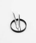 Two metal spoons and black scraper ring from 17 Piece Herb Grinder Cleaning Kit With Scrapers Spoons Long And Short Brushes And Storage Box.