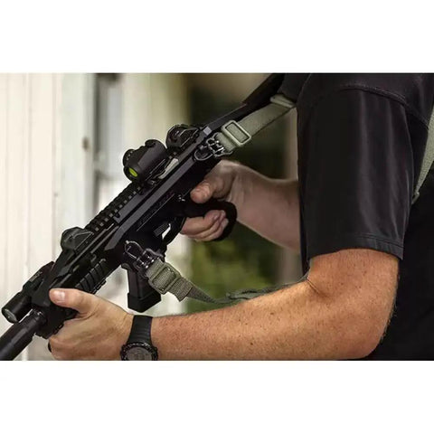Game Changer Universal QD Wire Loop That Locks Dead Sure On 1.25 Inch Slings mounted on a tactical rifle with a green sling.
