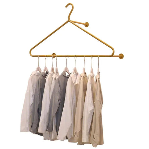 Score This Premium Wall Mount Clothes Rack With Heavy Duty Steel Shelves And Heart Shaped Design To Level Up Your Boutique Floor Or Cozy Apartment Vibe, showcasing hanging shirts on a gold rack.