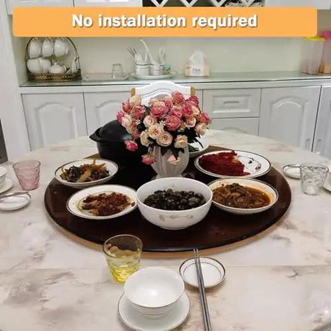 39 Inch Glass Lazy Susan Turntable With Six Super Slick Wheels Hella Sturdy Rotating Serving Tray set up with dishes on a dining table.