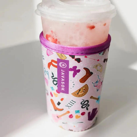 Premium Neoprene Iced Coffee Sleeve Keeps Your Daily Grind Crisp And Chill With Tough Fabric Coated Material And Reinforced Seams Built For Medium Cups Spanning Twenty Two To Twenty Eight Ounces Of Your Favorite Sip with pink design on medium cup.