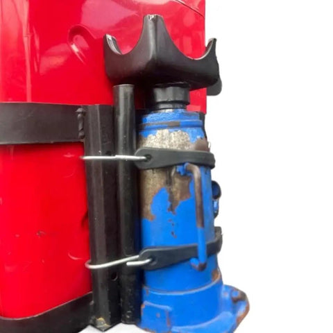 Close-up of Bottle Jack Axle Saddle Adapter for 2 Inch and 3 Inch Axle Tubes, heavy-duty steel construction, attached to a red jack