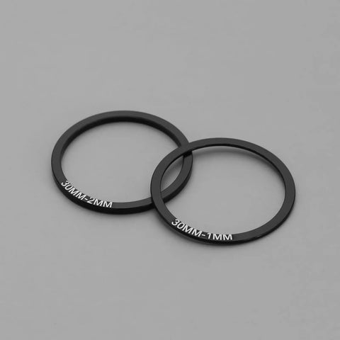 Close-up of 1mm and 2mm aluminum spacers from 12 Piece 30Mm Bike Bottom Bracket Washer Set With Stainless Steel Shims And Aluminum Spacers For BB86 BB91 BB92 BB30 PF30 Road Cranksets And Ride Ready Crankset Spacer Kit.