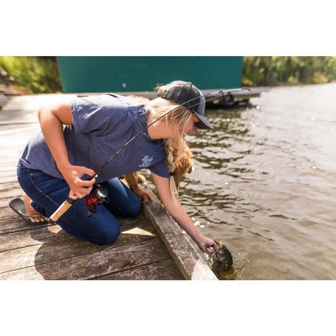 Person using Dock Runner Spinning Reel And Fishing Rod Combo 36 Inch Medium Action Multi Piece Rod Setup by a lake.