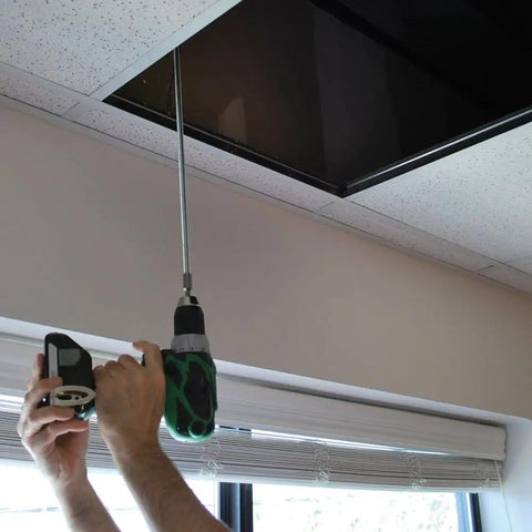 Person using an impact driver with Impact Driver Hanger Bolt Driver Bit Three Eighths Inch By Sixteen Thread for installation in ceiling.