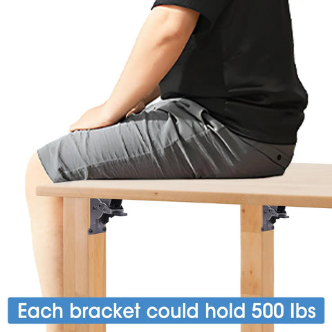 Person sitting on table showing 4 Pack Beefy Heavy Duty Locking Hinge Brackets For Folding Tables, 90 Degree Self Locking Hinges For Table Legs.