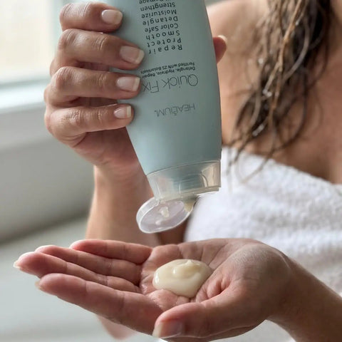 Quick Fix Leave In Hair Treatment Infuses Damaged Strands With Hella Hydration And Serious Shine For A Silky Smooth Finish Before Your Daily Blowout Session being dispensed onto a hand.