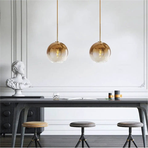 Modern Globe Pendant Light With Gradient Glass Shade, Gold Finish, 1 Light, Adjustable Height Chandelier For Dining Room, Kitchen, And Bedroom, E26 Base, Dope Mid Century Vibe, Premium Glass And Metal Fixture hanging above a dining table in a stylish room