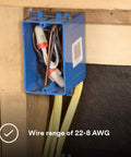 Solid As A Rock Tan And Red Wire Connectors For Twenty Two To Eight Gauge Cables in a blue electrical box on a wall.