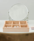 Slick Pine Wood Jewelry Organizer Tray With Six Compartments showing rings and pearls, placed on a vanity surface