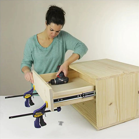 A woman installing Built Tough 12 Inch Side Mount Drawer Slides One Pair Full Extension Ball Bearing Cabinet Glides Auto Lock.