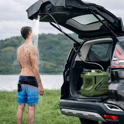 Man using Portable Camping Shower With Built-In Water Jug And Pump, Spill-Resistant Electric Outdoor Shower, 5-Gallon Food-Grade Water Tank.