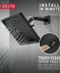 Three-Spray H2Okinetic Shower Head Matte Black 52684-BL with spray holes and water flow on a tiled wall.