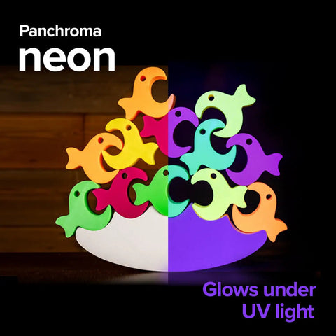 Colorful Panchroma neon fish figurines glowing under UV light, displaying vibrant hues and playful designs for creative use.