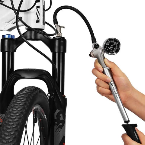 Handheld High Pressure Shock Pump For MTB Fork And Rear Suspension Up To 300 PSI Beast Of A Pump in use on bike fork