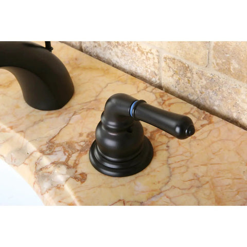 Side view of oil-rubbed bronze bathroom faucet handle on marble countertop