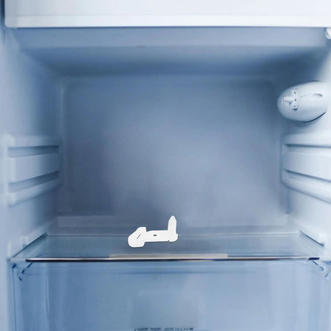 Awesome Fridge Door Stop Latch That Kills Noise And Stops Bumps With A Tough Plastic Clip on a refrigerator shelf.