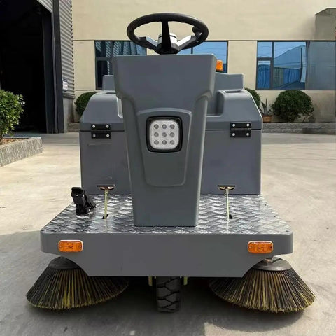 Heavy Duty Ride On Commercial Floor Sweeper For Concrete Industrial Cleaning Machine Warehouse Parking Lot And Logistics Center Maintenance Equipment Big Deal, front view with steering and scrubbers.
