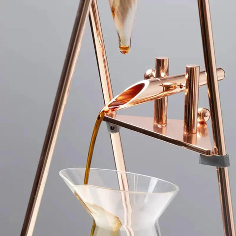Top Tier Iced Coffee Maker And Cold Brew Drip Tower With 800Ml Borosilicate Glass Pitcher pouring coffee into a glass.