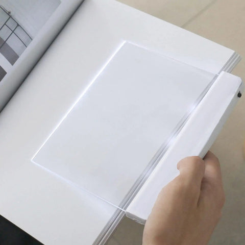 Person using Flat Page Book Light With Clear LED Panel For Reading In Bed At Night Full Page Illumination Lamp Board