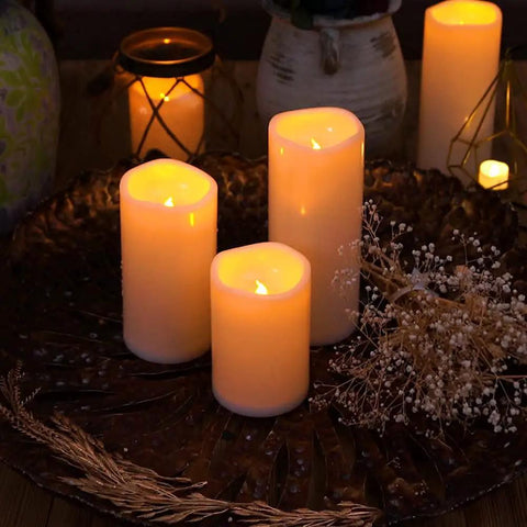 Outdoor Waterproof Flameless LED Pillar Candles Set 6 8 10 Inch With Remote And Timer Battery Operated Weatherproof Plastic Candles In Ivory White glowing on table