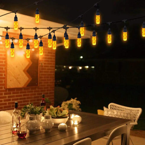 Flickering Flame Outdoor String Lights 27 Ft USB Charged Waterproof Patio Decor with warm yellow LED bulbs hanging over patio table