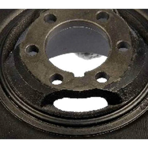 Close-up of black harmonic balancer for Kia Sportage 1995 to 2002, showing six-hole design and keyway for serpentine drive belt