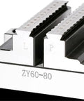 Close-up of a CNC turntable fixture with engraved measurements, sturdy design for setting up self centering concentric vise.