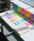 Bright Color 3x3 Sticky Notes Pack With 18 Pads And 50 Sheets Each Super Sticky Recyclable Note Set For Home Office School Vibrant 9 Color Assortment Easy Organization On Point Reminders displayed on a desk with notes and stationery.