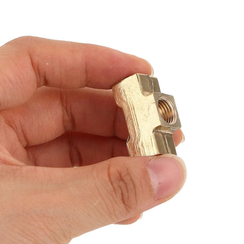 Brass Tee Fitting With Female Thread For Pneumatic Air Hose Connectors held in hand showing compact block shape